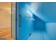 Attic closet with painted blue walls, shelving, and wood floors at 2436 Green Hollow Ct, Conyers, GA 30012