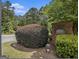 Brick sign for 'River Ridge' at the community entrance amid lush greenery at 2436 Green Hollow Ct, Conyers, GA 30012