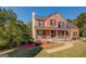 Charming two-story brick home with a inviting front porch and well-manicured landscaping at 2436 Green Hollow Ct, Conyers, GA 30012