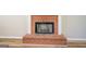 Close up of the brick fireplace in the living room with white mantel and hardwood floors at 2436 Green Hollow Ct, Conyers, GA 30012