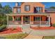 Inviting front porch with gray wood railing and a walkway with red mulch landscaping at 2436 Green Hollow Ct, Conyers, GA 30012