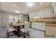 Kitchen with white cabinets, breakfast table with chairs, and modern appliances at 2436 Green Hollow Ct, Conyers, GA 30012