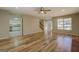 Open living room with hardwood floors and access to kitchen, foyer, and staircase at 2436 Green Hollow Ct, Conyers, GA 30012