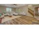 Bright, staged living room boasts hardwood floors, neutral walls, and a modern design at 2436 Green Hollow Ct, Conyers, GA 30012
