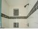 Close up of a beautifully tiled shower with sleek fixtures and built-in niche storage at 2436 Green Hollow Ct, Conyers, GA 30012