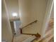 Carpeted staircase leading to the main level with decorative tile and wood flooring at 2436 Green Hollow Ct, Conyers, GA 30012