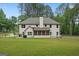 Rear view of two-story house with a screened porch, patio, and grill at 337 Paynes Lake Rd, Carrollton, GA 30116