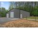 Large metal barn with two roll-up doors, providing ample space for storage or workshop at 337 Paynes Lake Rd, Carrollton, GA 30116