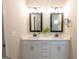 Bathroom featuring double vanity with white cabinets, quartz countertop, and black framed mirrors at 337 Paynes Lake Rd, Carrollton, GA 30116