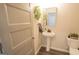 Half bathroom features a pedestal sink, toilet, modern flooring, and gray paint at 337 Paynes Lake Rd, Carrollton, GA 30116