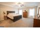 Bright Primary bedroom features a tray ceiling, soft carpet, and lots of natural light at 337 Paynes Lake Rd, Carrollton, GA 30116