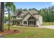 Side view of the home showcasing the garage, spacious yard, and attractive design at 337 Paynes Lake Rd, Carrollton, GA 30116