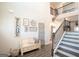 Bright two-story foyer with staircase, bench seating, and decorative wall art at 337 Paynes Lake Rd, Carrollton, GA 30116