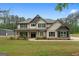 Charming two-story home with a well-manicured lawn, covered porch, and black-trimmed windows at 337 Paynes Lake Rd, Carrollton, GA 30116