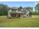 Inviting home featuring a covered porch, manicured lawn, and black window trim at 337 Paynes Lake Rd, Carrollton, GA 30116