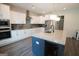 Contemporary kitchen with white cabinets, granite countertops, and a dark center island at 337 Paynes Lake Rd, Carrollton, GA 30116