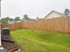 A verdant backyard with a wood fence and air conditioning unit at 165 Woodgate Cir, Fayetteville, GA 30214