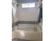 Well-lit bathroom with tub, shower, and modern white tile at 165 Woodgate Cir, Fayetteville, GA 30214