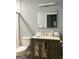 Bathroom vanity features decorative cabinets, a mirror, and a sink with granite countertop at 165 Woodgate Cir, Fayetteville, GA 30214