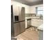 Bright kitchen with white cabinets, stainless steel fridge, and granite countertops at 165 Woodgate Cir, Fayetteville, GA 30214