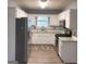 Modern kitchen featuring white cabinets, stainless steel appliances, and granite countertops at 165 Woodgate Cir, Fayetteville, GA 30214