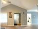 Open living room with cathedral ceiling, neutral walls, and view into the kitchen at 165 Woodgate Cir, Fayetteville, GA 30214