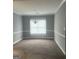 Spacious living room with carpeted floors, chandelier, and neutral walls at 165 Woodgate Cir, Fayetteville, GA 30214