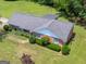Aerial view of a well-maintained brick home with a gray roof, manicured lawn, and mature landscaping at 114 Overlook Dr, Mcdonough, GA 30252
