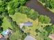 Aerial view of the home surrounded by large landscaped yard and winding creek at 114 Overlook Dr, Mcdonough, GA 30252