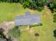 Aerial perspective of a home with a gray roof, surrounded by a lush green yard and mature trees at 114 Overlook Dr, Mcdonough, GA 30252