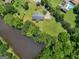 Aerial view of home and property showing large landscaped yard, creek and mature trees at 114 Overlook Dr, Mcdonough, GA 30252
