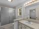 Bathroom with shower and vanity, featuring a large mirror and sink at 114 Overlook Dr, Mcdonough, GA 30252