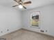 Bedroom featuring neutral carpet, a ceiling fan, and natural light from the window at 114 Overlook Dr, Mcdonough, GA 30252