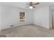 Bedroom with neutral carpet, ceiling fan, and window with backyard view at 114 Overlook Dr, Mcdonough, GA 30252