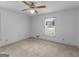 Bedroom with neutral carpet, ceiling fan, and a window with a wooded view at 114 Overlook Dr, Mcdonough, GA 30252