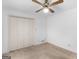 Bedroom featuring neutral carpet, closet, a ceiling fan, and natural light from the window at 114 Overlook Dr, Mcdonough, GA 30252
