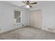 Bedroom with neutral carpet, a large window, closet, and ceiling fan at 114 Overlook Dr, Mcdonough, GA 30252