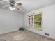 Bedroom features neutral carpet and a window overlooking backyard at 114 Overlook Dr, Mcdonough, GA 30252