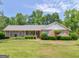 Charming brick home with a well-manicured lawn and mature landscaping, creating a welcoming curb appeal at 114 Overlook Dr, Mcdonough, GA 30252