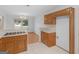 Spacious kitchen area flowing into a dining space, featuring wooden cabinetry and tile flooring at 114 Overlook Dr, Mcdonough, GA 30252