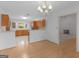 Open-concept kitchen area adjacent to dining space, showcasing wooden cabinets and ample natural light at 114 Overlook Dr, Mcdonough, GA 30252