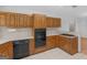 Functional kitchen with wooden cabinets, white countertops, and sleek black appliances for a modern feel at 114 Overlook Dr, Mcdonough, GA 30252