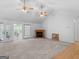 Bright living room features a cozy fireplace, carpet flooring and ample natural light at 114 Overlook Dr, Mcdonough, GA 30252