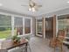 Charming sunroom with tile floors, large windows, ceiling fan, and access to the backyard at 114 Overlook Dr, Mcdonough, GA 30252