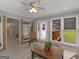 Bright sunroom with wood-look floors, ceiling fan, brick accents, and views of the backyard at 114 Overlook Dr, Mcdonough, GA 30252