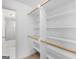 Walk-in closet with custom shelving and a view of the bathroom at 114 Overlook Dr, Mcdonough, GA 30252