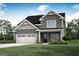 Charming two-story home with a two car garage and landscaped front yard at 309 Limestone Circle, Conyers, GA 30013