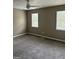 Bedroom featuring plush gray carpet, neutral paint, a ceiling fan, and two large windows at 1321 Lakeview Nw Dr, Conyers, GA 30012