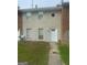 Townhouse exterior featuring a painted brick facade, white door and windows, and a small front yard at 1321 Lakeview Nw Dr, Conyers, GA 30012