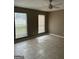 A spacious living room with tile floors, neutral walls, and two large windows for natural light at 1321 Lakeview Nw Dr, Conyers, GA 30012